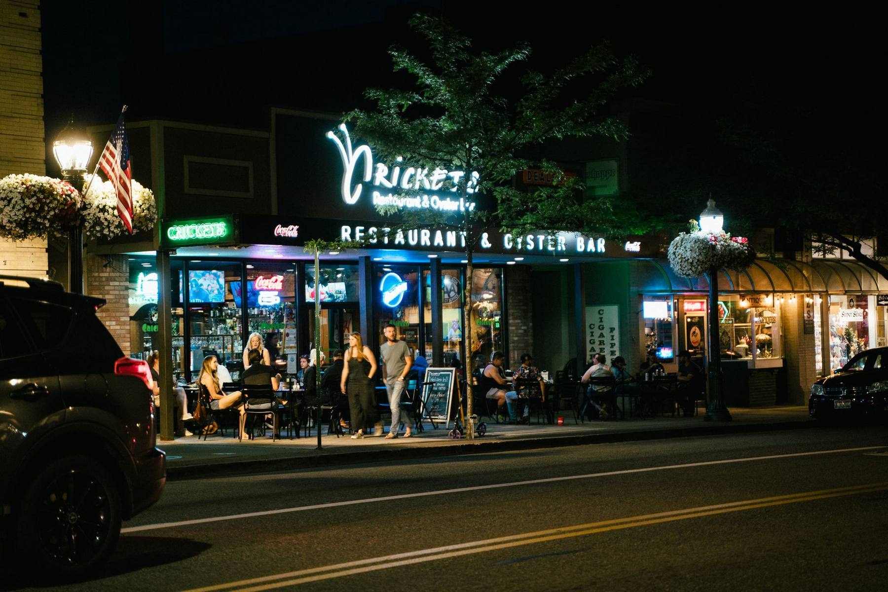 Lively pedestrian street lined with lit restaurants at night