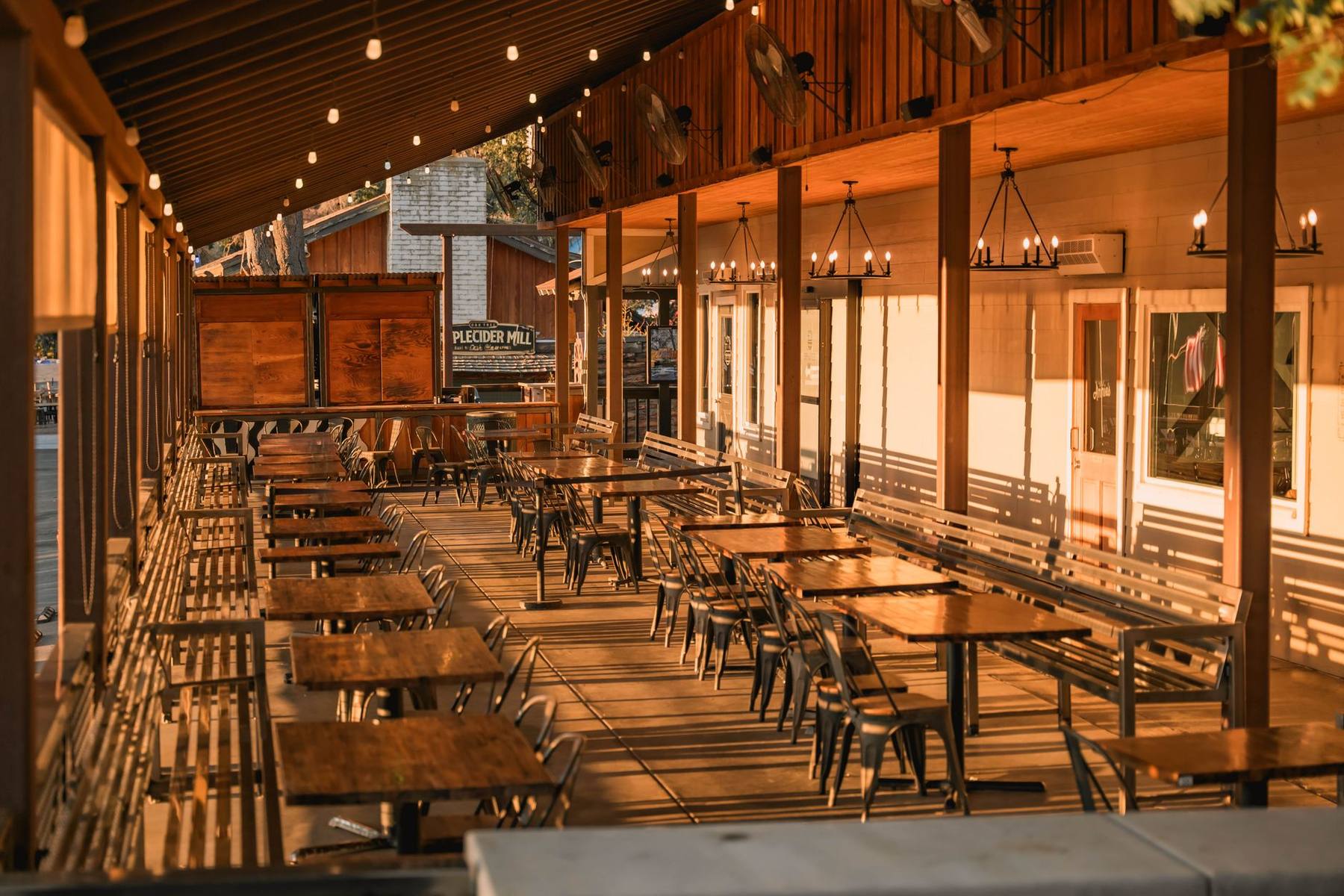 Warmly lit outdoor restaurant patio in the evening