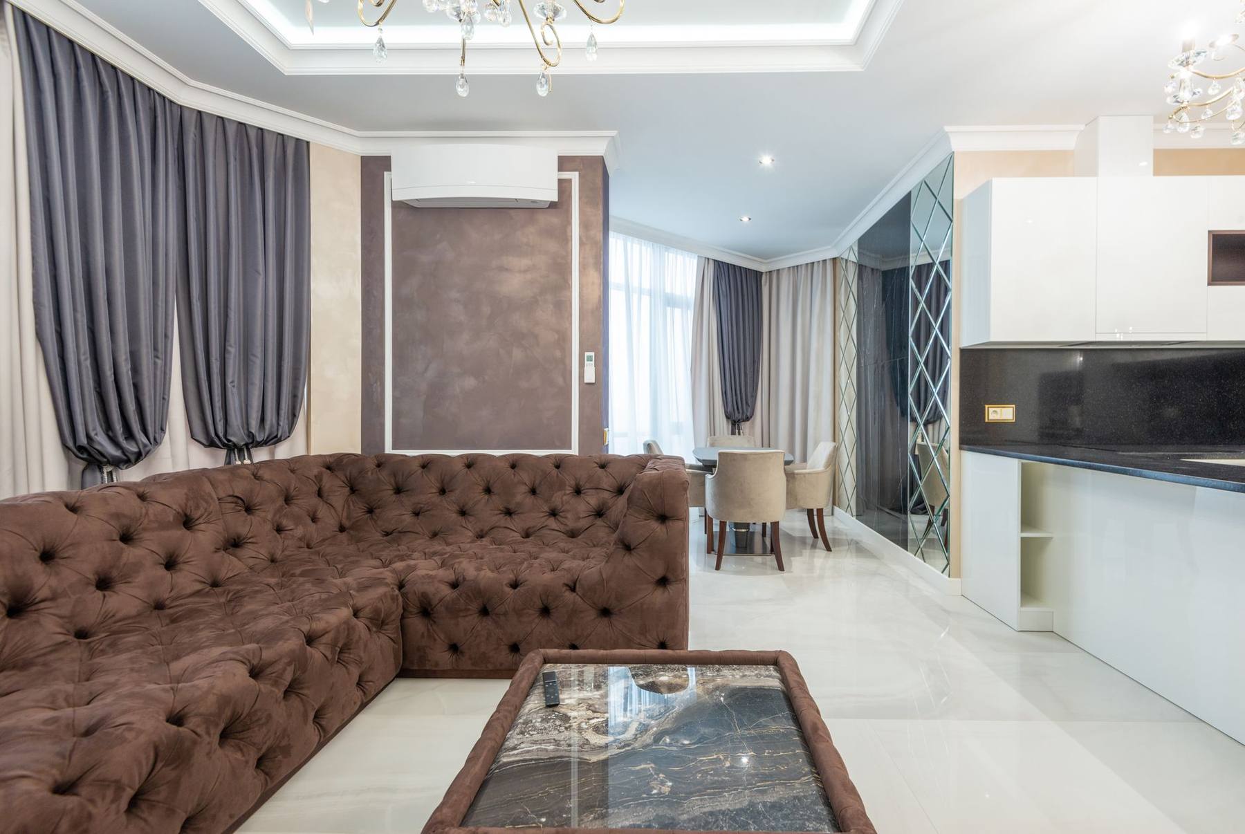Bright, spacious suite living room with a sofa and large windows